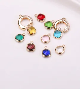 Detailed view of colorful square crystal pendants with gold-plated copper frames