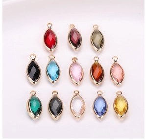 Macro detail of assorted marquise faceted crystal glass pendants with gold metal edging