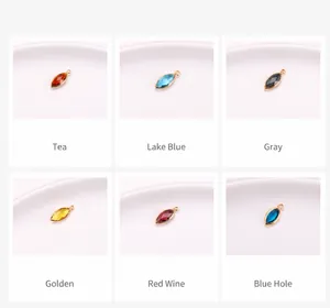 Detailed macro view of marquise-cut crystal pendants in six colors with gold-plated edges