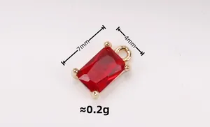 Macro detail of a 7x4mm red crystal rectangle pendant with gold-plated prong setting