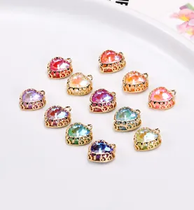 Macro detail of colorful heart crystal pendants with golden copper filigree for DIY jewelry