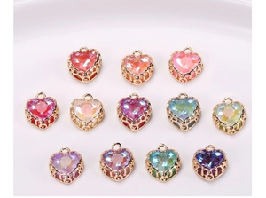 Macro view of crystal heart pendants with gold crown edge for DIY jewelry making