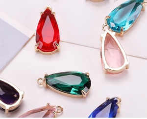 Macro view of colorful teardrop crystal pendants with gold claw settings for jewelry DIY