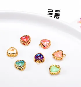 Close-up of heart-shaped colorful crystal pendants with gold lace hollow bases