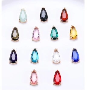 Macro shot of colorful teardrop faceted glass charms with metal claw settings for DIY jewelry