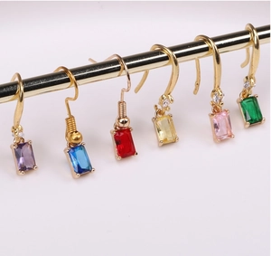 Detailed display of six gold-plated rectangle crystal earrings in various vibrant colors
