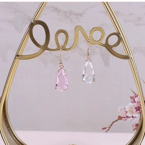 Macro detail of teardrop glass pendants with faceted crystal in pink and white