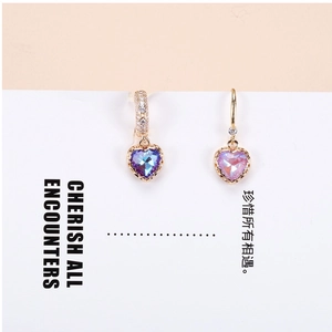 Detail of colorful crystal heart pendant with gold-plated lace and micro-inlay finish