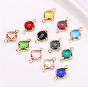 Flat lay of colorful square crystal connectors with gold plated edges for DIY jewelry making