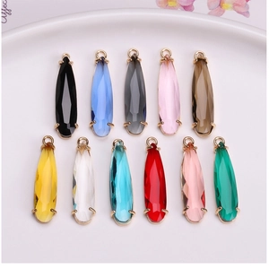 Detailed close-up of multi-colored teardrop crystal pendants with gold plated edges