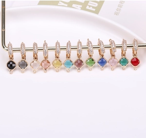 Close-up of twelve colorful square faceted crystal pendants with gold pavé connectors