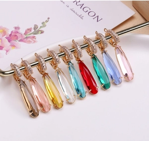 Detailed macro view of gold-plated teardrop crystal pendants in nine vibrant colors