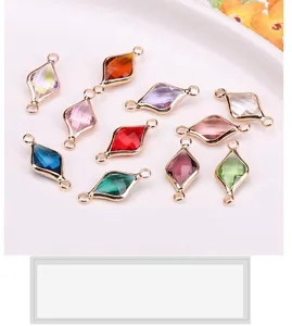Macro shot of 10 colorful diamond-shaped glass pendants with gold-plated copper frames