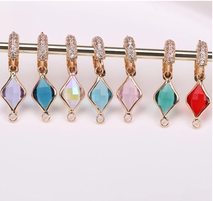 Detail of colorful gold-plated rhombus charms with zircon pave for DIY jewelry
