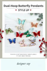 Macro shot of 14K gold butterfly pendants with colorful crystals and double jump rings