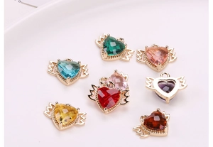 Close-up of heart-shaped pendants with wings in seven colors for DIY jewelry making