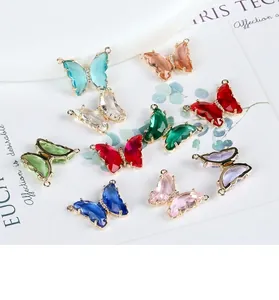 Macro detail of colorful butterfly crystal charms with 14K gold plated dual loops