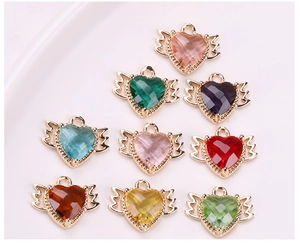 Macro view of winged heart pendants in nine colors for DIY jewelry making accessories