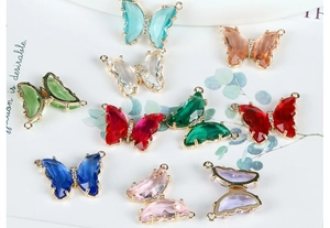 Detailed macro view of 14K gold-plated crystal butterfly pendants for DIY jewelry making