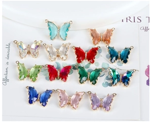 Macro view of 14K gold plated butterfly pendants with colorful faceted crystals