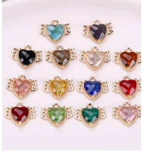 Macro view of assorted colorful crystal heart wing charms for DIY jewelry making