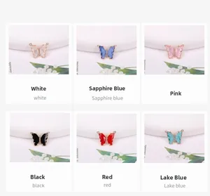 Detailed view of 14K gold-filled butterfly charms set with crystals in six vibrant colors