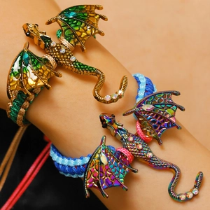 Close-up of vintage dragon bracelet featuring colorful enamel wings and crystal details