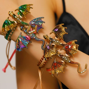 Detail showing hand-woven dragon bracelets with colorful enamel wings and rhinestones