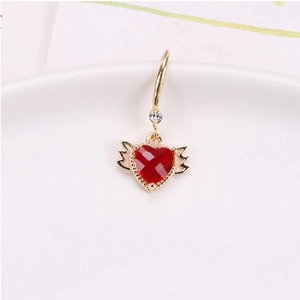 Detail of red crystal heart pendant with gold wings and sparkling rhinestone accent