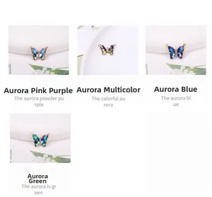 Macro view of 14K gold butterfly pendants with colorful iridescent crystal inserts