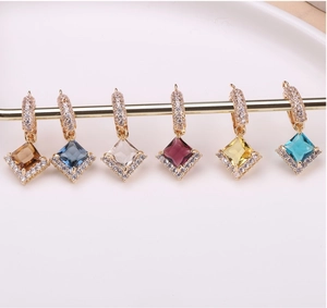 Macro view of square crystal drop earrings with pave diamond settings in six colors