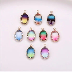 Macro view of nine gradient tourmaline crystal oval pendants with gold claw settings