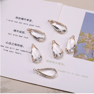 Detailed view of six clear crystal waterdrop pendants with 14K gold plated settings