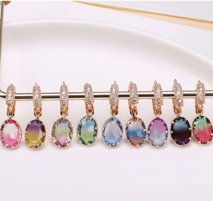 Detail view of nine gradient tourmaline crystal oval pendants with micro-pave zircon hoops