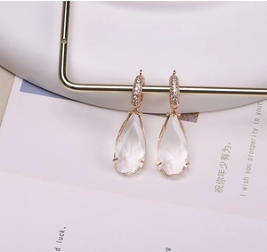 Macro shot of 14K gold-plated teardrop crystal earrings with micro-inlaid zircon details