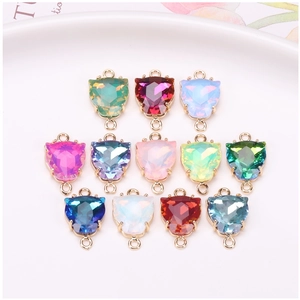Close-up of 12 colorful faceted leopard-head gemstone pendants for DIY jewelry making