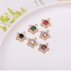 Detailed view of colorful star pendants with zircon micro-pave in gold-plated copper