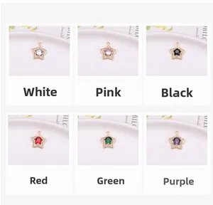 Detail view of gold-plated star pendants with multi-color zircon stones and crystal inlay