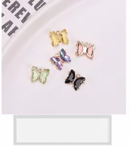 Close-up of crystal butterfly pendants in various colors with gold-plated metal base