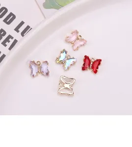 Macro detail of butterfly charms in crystal and gold plated copper for DIY jewelry
