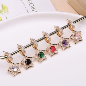 Star-shaped gold charms set with vibrant zirconia stones and pavé accents for jewelry