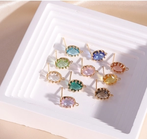 Detail of 14K gold-filled oval crystal stud earring bases with side loop for jewelry DIY