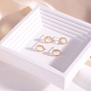 14K gold filled oval crystal stud earrings with 925 silver pins on champagne satin