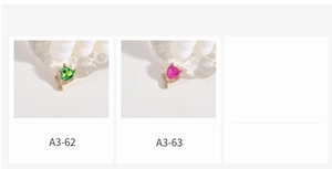 Detail view of heart-shaped emerald green and rose pink crystal pendants for DIY jewelry