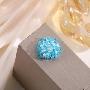 Detail of handcrafted blue crystal and white pearl flower charm for hair accessories