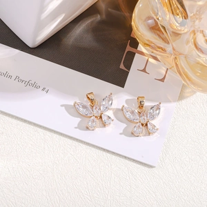Macro detail of gold plated butterfly charms with sparkling crystals for DIY jewelry