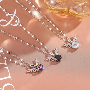 Macro detail of three elegant reindeer horn pendants with colorful zircon and fine stones
