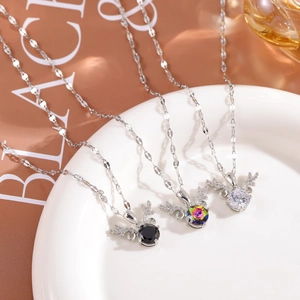 Detailed view of three elegant reindeer antler necklaces with colorful crystal pendants