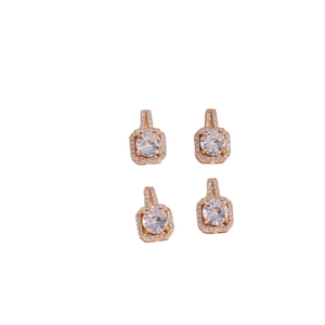 Close-up of four rose gold halo stud earrings with square cubic zirconia stones