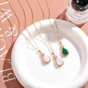 Elegant gold plated necklace with three colorful teardrop pendants and sparkling crystals